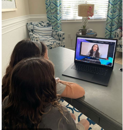 Daughters watch Women in Tech panelist on a laptop. International Women's Day 2022